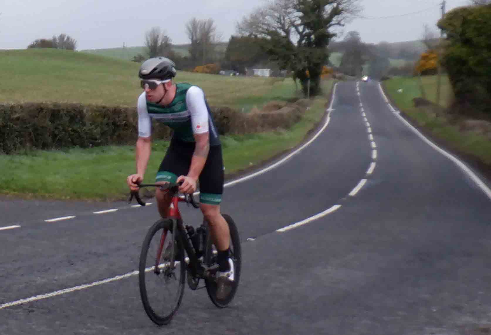 Peter McLean is hanging on, but the headlights of the bunch are looming in the background