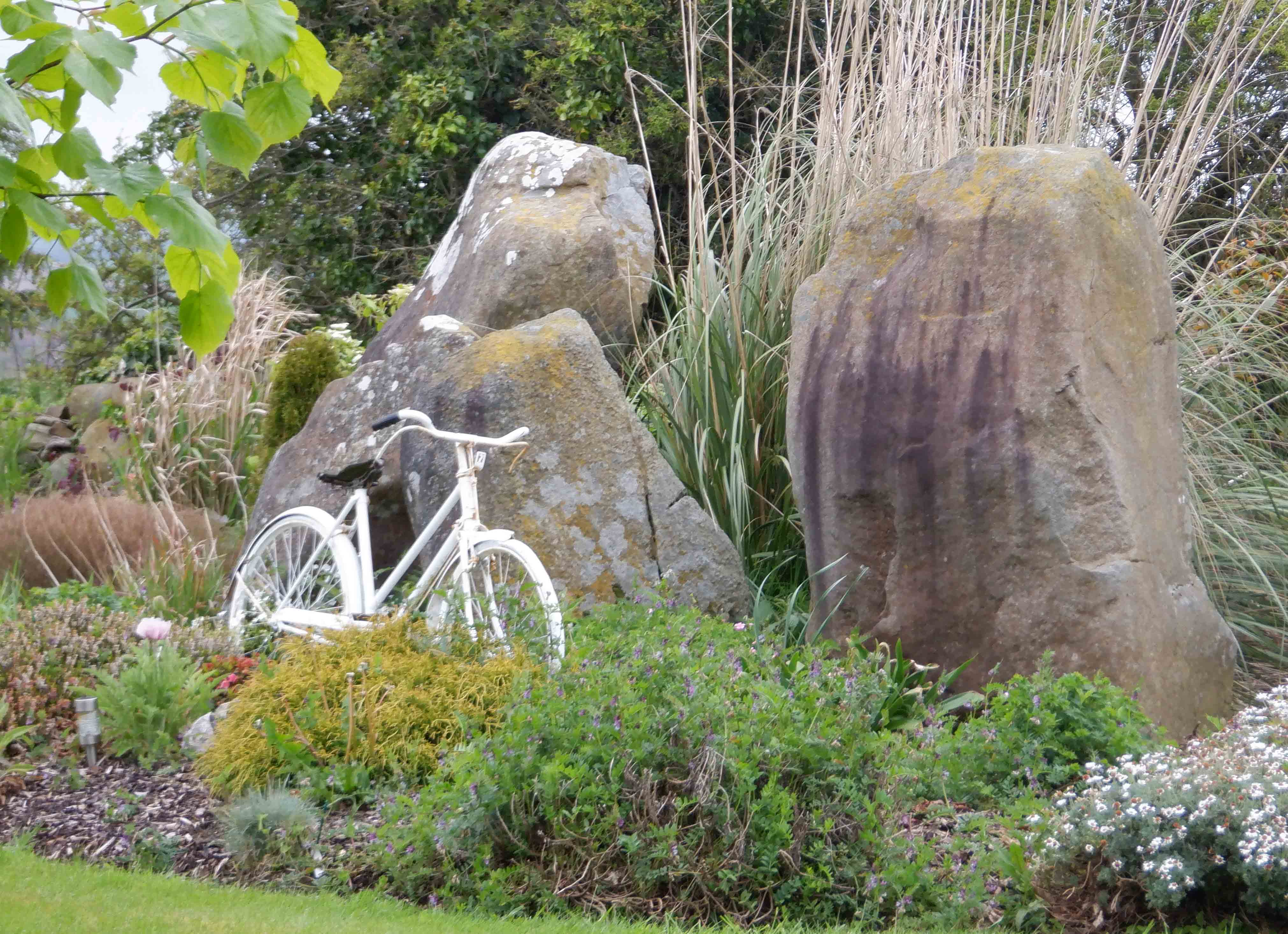 What form of white transport sits among the standing stones at no. 32?